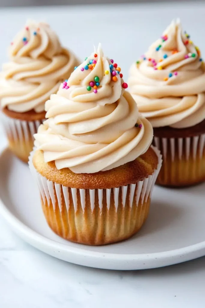 cupcakes with pudding frosting topped with sprinkles
