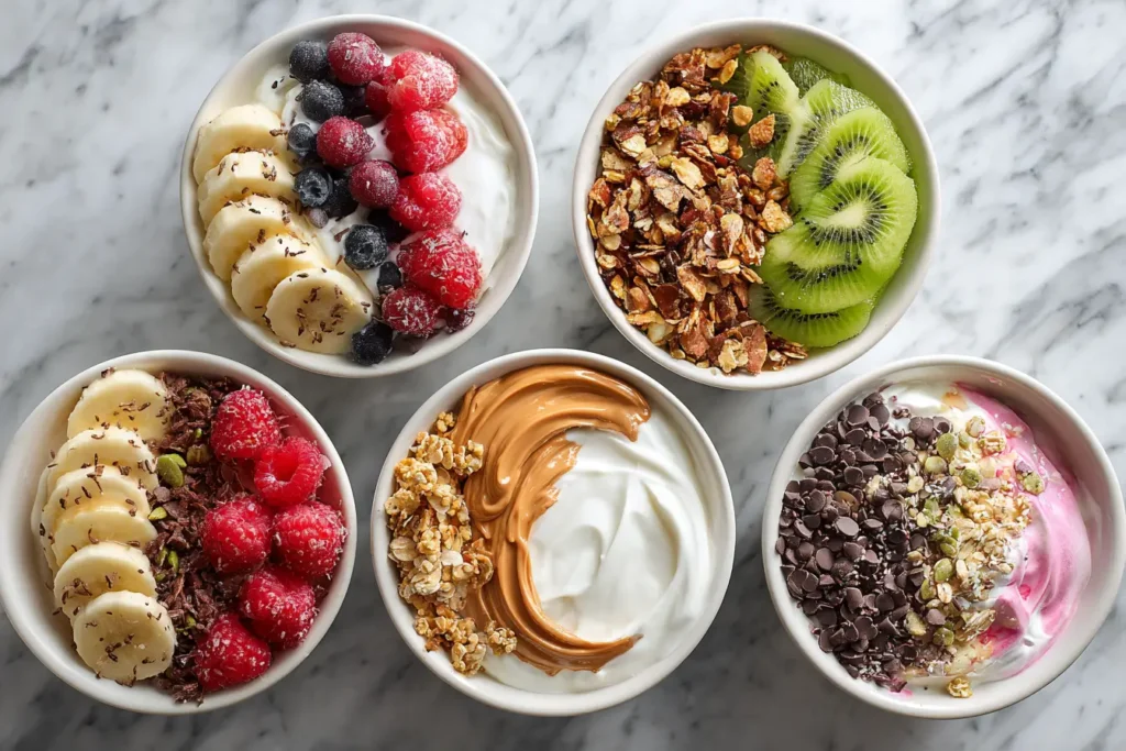 Five colorful high protein yogurt bowls with a variety of fresh toppings