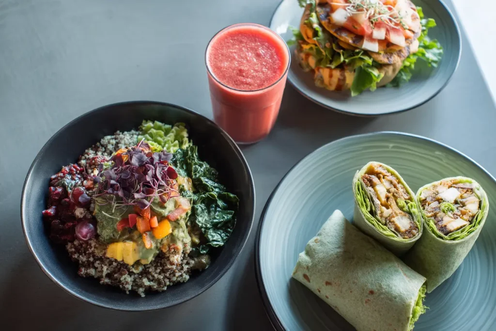 healthy fast food meal combo with quinoa bowl, veggie wrap, smoothie, and lettuce burger